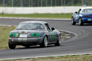 Joe Swearingen's Spec Miata Mazda Miata chases Greg Blaser's Spec Miata Mazda Miata