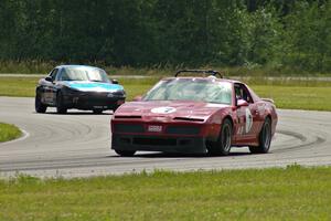 Tom Koetter's American Sedan Pontiac Firebird and Bruce Andersen II's Spec Miata Mazda Miata