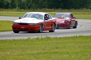 Tom Fuehrer's STO Ford Mustang battles the ITR Porsche 911 of Shannon Ivey