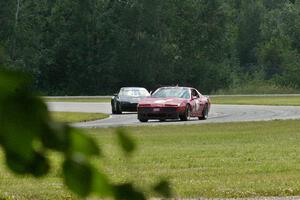 Tom Koetter's American Sedan Pontiac Firebird and Bruce Andersen II's Spec Miata Mazda Miata