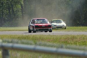 Dan Corgard's Spec Miata Mazda Miata returns to the track behind Mark Brakke's H Production Honda Civic.