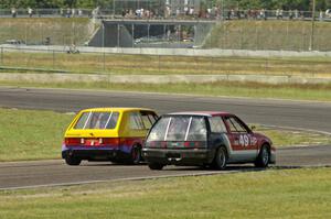 Jimmy Griggs's GTL VW Rabbit and Mark Brakke's H Production Honda Civic go side-by-side into turn 4.