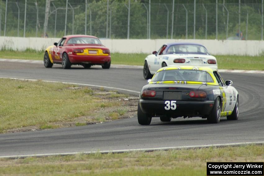 Greg Youngdahl leads Jack Randall and Dan Corgard all in Spec Miata Mazda Miatas.