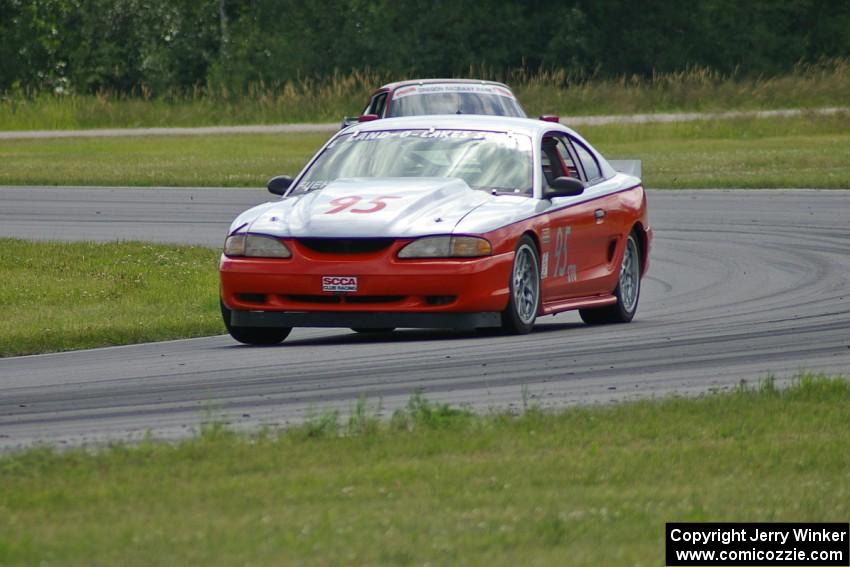 Tom Fuehrer's STO Ford Mustang battles the ITR Porsche 911 of Shannon Ivey