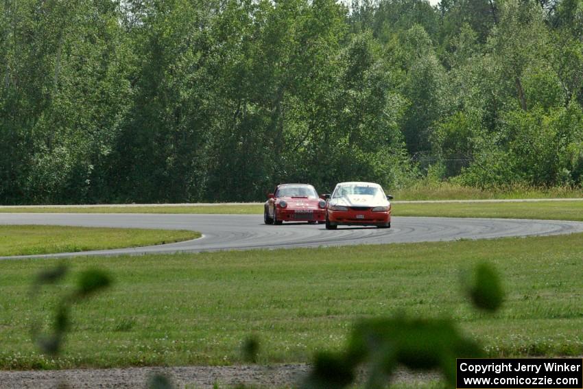 Tom Fuehrer's STO Ford Mustang battles the ITR Porsche 911 of Shannon Ivey