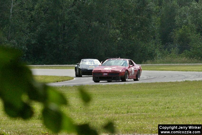 Tom Koetter's American Sedan Pontiac Firebird and Bruce Andersen II's Spec Miata Mazda Miata