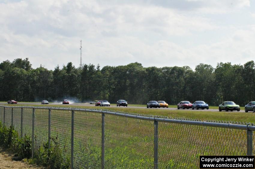 Dan Corgard's Spec Miata Mazda Miata spins off in turn 3.