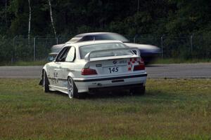 Chris Elliott's ITE BMW M3 spins at the inside of turn 3