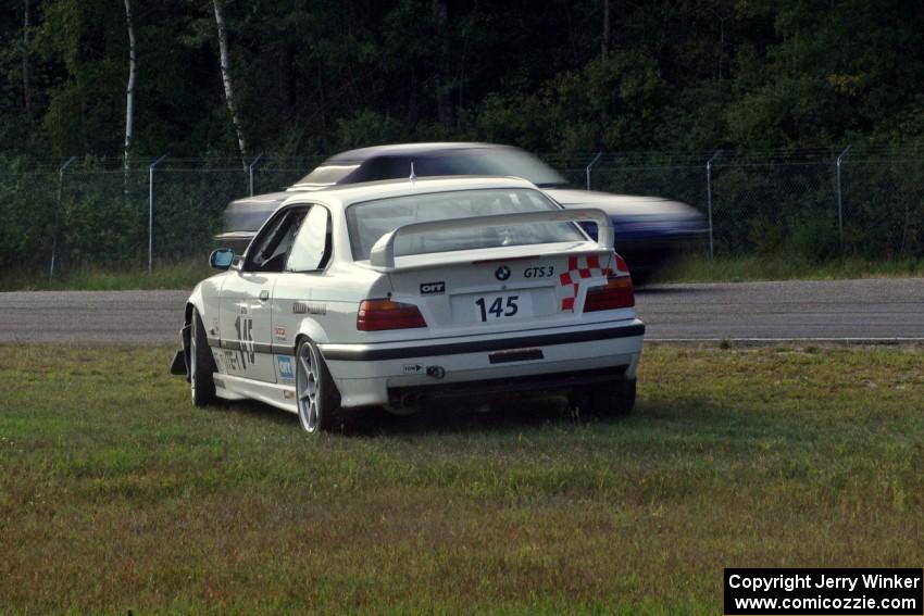 Chris Elliott's ITE BMW M3 spins at the inside of turn 3