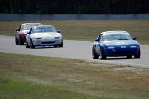 Lon Blaser, Samantha Silver and Greg Youngdahl battle in their Spec Miata Mazda Miatas