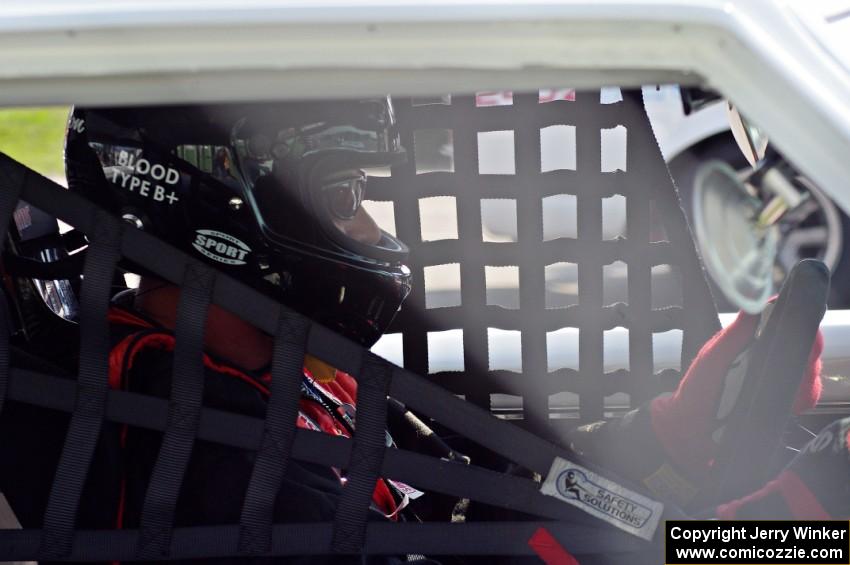 Shannon Ivey sits in his Chevy Camaro