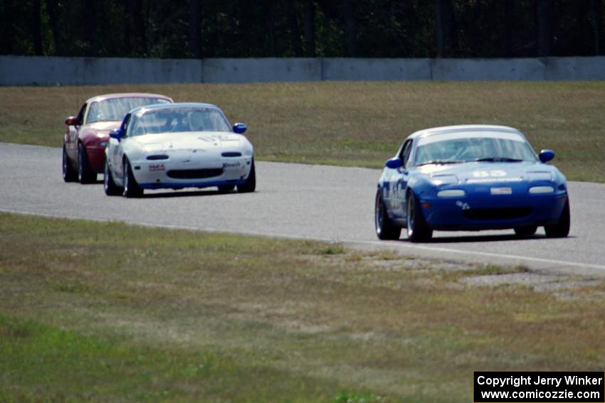 Lon Blaser, Samantha Silver and Greg Youngdahl battle in their Spec Miata Mazda Miatas