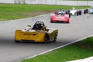 The Spec Racer Fords of Jed Copham and Dave Copham lead a pack of Formula Fords through turns 12 and 13