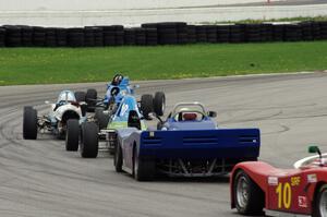 Five cars run nose-to-tail through turn 13