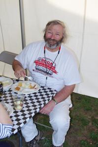 Jim Gillen enjoys a piece of his own birthday cake at the LOL worker party after the races.