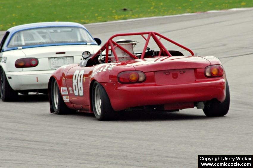 Jon Brakke's E Production Mazda Miata chases Samantha Silver's Spec Miata Mazda Miata