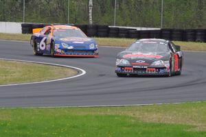 Michael Self's Chevy Impala ahead of Derek Thorn's Ford Fusion