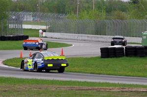 Michael Self's Chevy Impala ahead of Derek Thorn's Ford Fusion and Dallas Montes's Chevy Impala