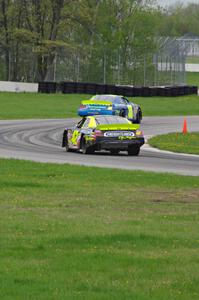 John Wood's Toyota Camry ahead of Taylor Cuzick's Ford Fusion