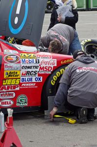 Daryl Harr's Chevy Impala gets some work done after practice.