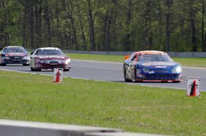 Derek Thorn's Ford Fusion ahead of Cameron Hayley's Ford Fusion and Michael Self's Chevy Impala.