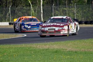 Cameron Hayley's Ford Fusion leads Derek Thorn's Ford Fusion through the carousel.