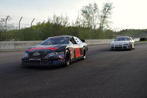 Michael Self's Chevy Impala followed closely by Andrew Ranger's Dodge Charger