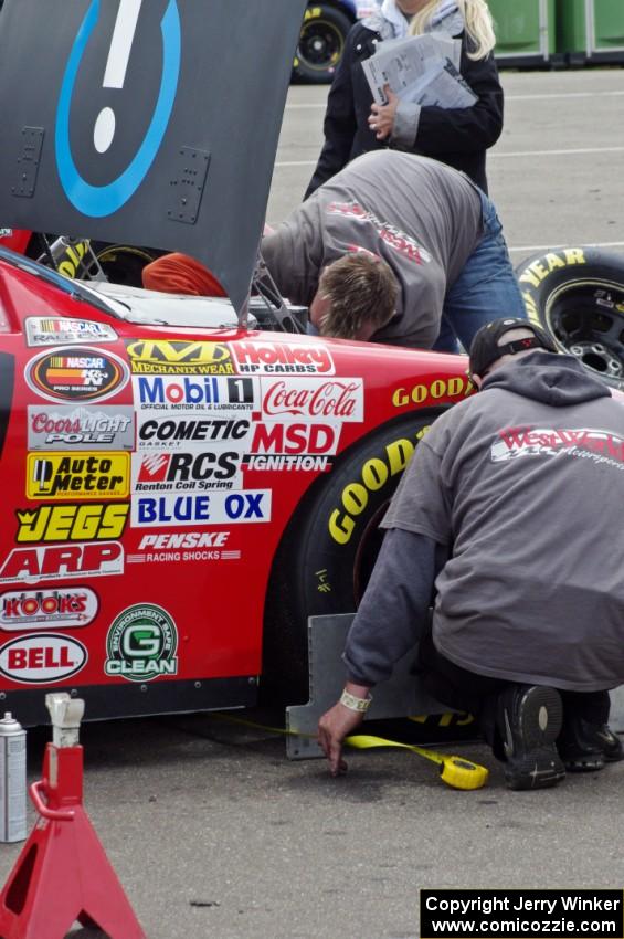 Daryl Harr's Chevy Impala gets some work done after practice.