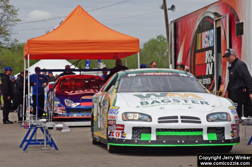 Andrew Ranger's Dodge Charger and Dylan Lupton's Ford Fusion go through the tech line