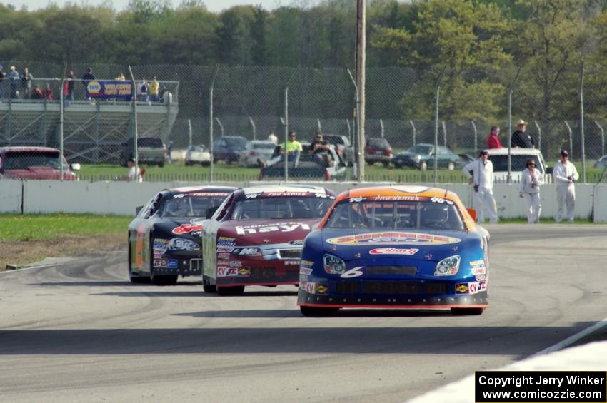 Derek Thorn's Ford Fusion ahead of Cameron Hayley's Ford Fusion and Michael Self's Chevy Impala.