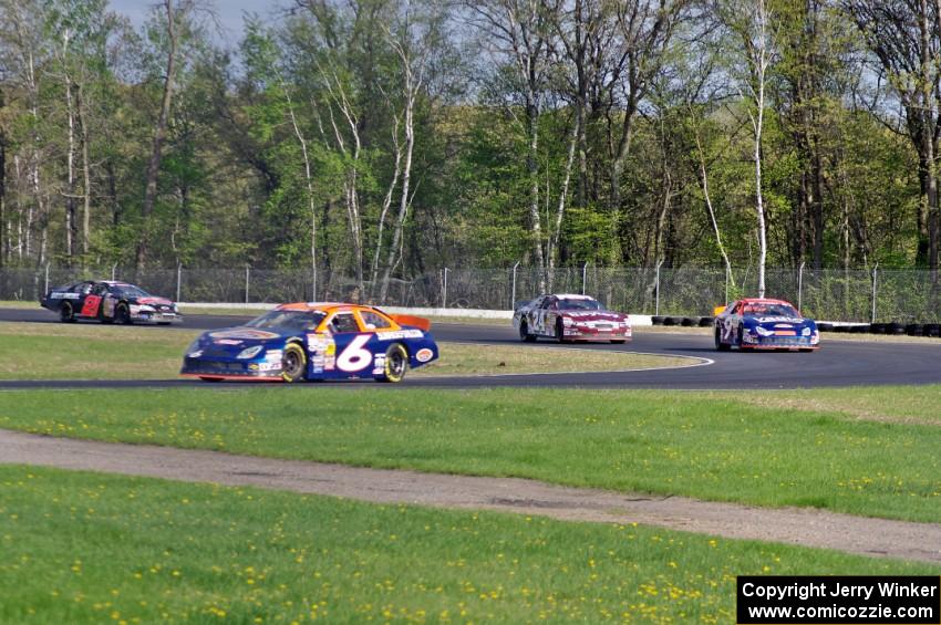 Derek Thorn's Ford Fusion leads Dylan Lupton's Ford Fusion, Cameron Hayley's Ford Fusion and Michael Self's Chevy Impala