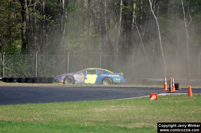 John Wood's Toyota Camry spins off at the carousel.