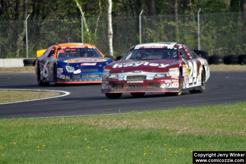 Cameron Hayley's Ford Fusion leads Derek Thorn's Ford Fusion through the carousel.