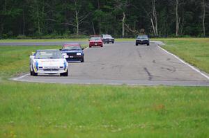 Five cars stream through turns 3 and 4.