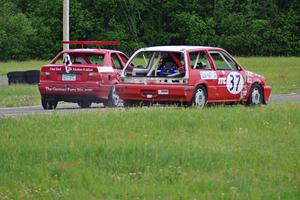 Team Party Cat Honda Civic loses power coming out of turn 4 as the Flying Circus BMW E36 passes by.