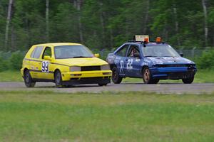 Cockroach Racing Ford Escort and Team Short Bus VW Golf dive into turn 3.