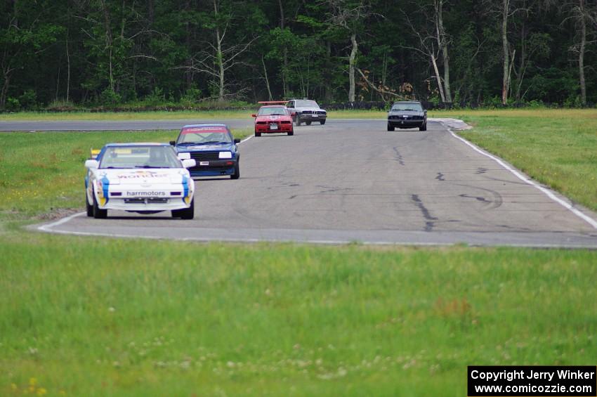 Five cars stream through turns 3 and 4.