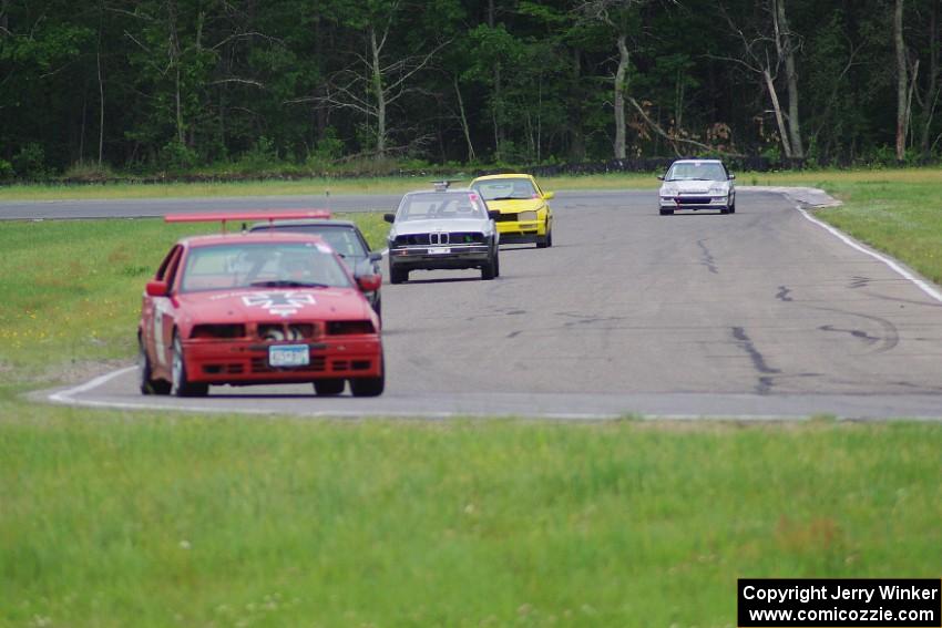 Five cars stream through turns 3 and 4.