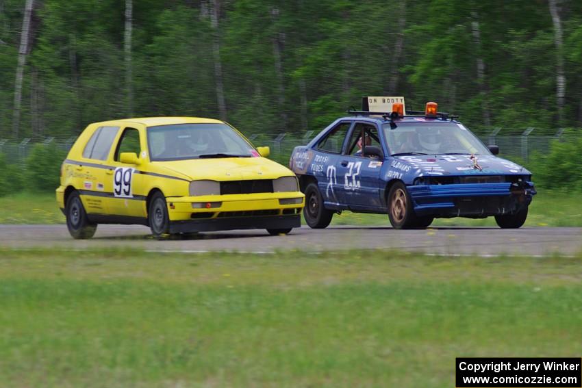 Cockroach Racing Ford Escort and Team Short Bus VW Golf dive into turn 3.