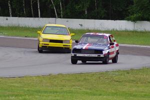 British American Racing BMW 318i and Team Short Bus VW Golf in the carousel.