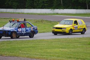 Cockroach Racing Ford Escort and Team Short Bus VW Golf in the carousel.