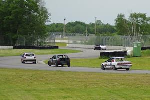 Five cars come out of the carousel and into the esses.