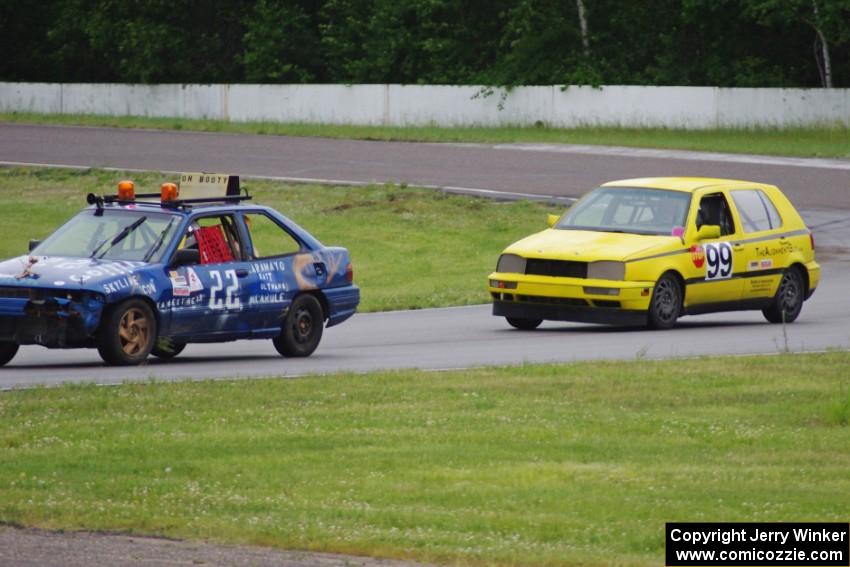 Cockroach Racing Ford Escort and Team Short Bus VW Golf in the carousel.
