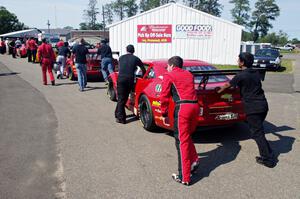 Pete Halsmer's Chevy Camaro and Cameron Lawrence's Chevy Camaro head into post-qualifying inspection.