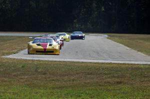 The field streams into turn four on the second lap.