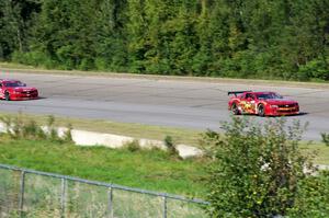 Bob Stretch's Chevy Camaro and Pete Halsmer's Chevy Camaro battle for the lead in TA2