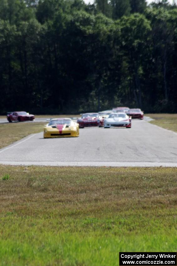 The field streams into turn four on the first lap.