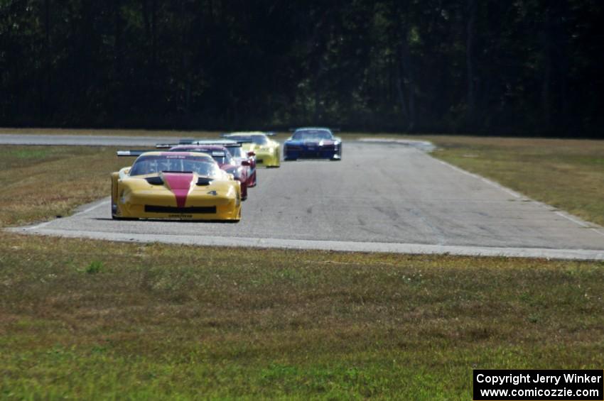 The field streams into turn four on the second lap.