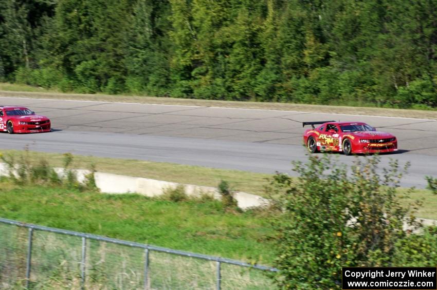 Bob Stretch's Chevy Camaro and Pete Halsmer's Chevy Camaro battle for the lead in TA2