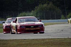 Bob Stretch's Chevy Camaro and Cameron Lawrence's Chevy Camaro battle for second in TA2